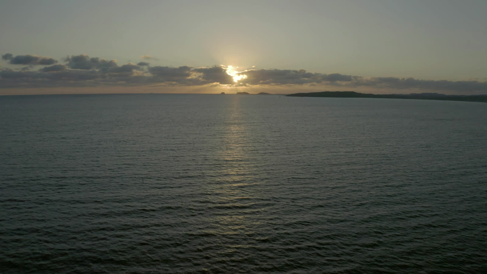Still water beyond the terrace at dusk